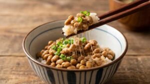 AI-generated illustration of sticky natto fermented soybeans being stirred with chopsticks
